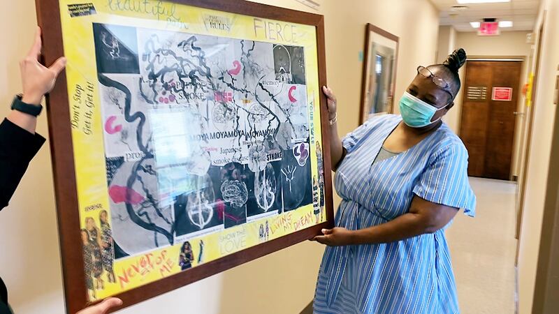 Trisha Moore received a piece of art on Monday from the Frazier Rehabilitation Institute...