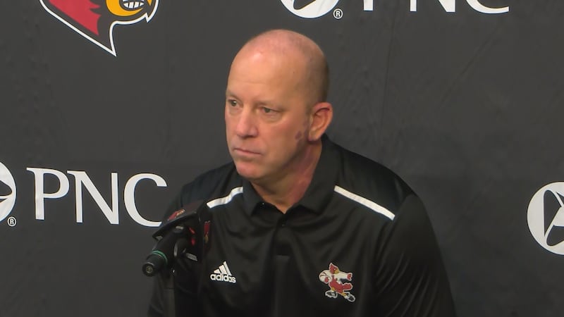 University of Louisville head football coach Jeff Brohm takes questions from a member of the...