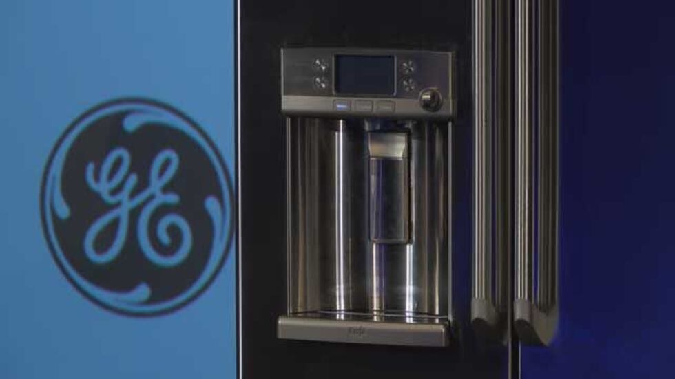 The refrigerator features a hot water dispenser paired with a Keurig K-Cup single-cup brewer....