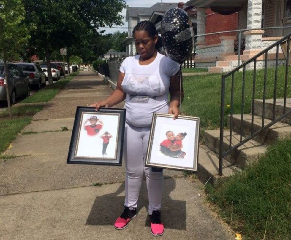 Micheshia Norment displays photos of her son Dequante. (Source: Maira Ansari/WAVE 3 News)
