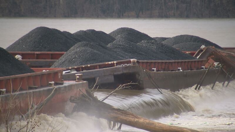 Barges loaded with coal on the Ohio River. The barges broke loose from the tugboat that was...