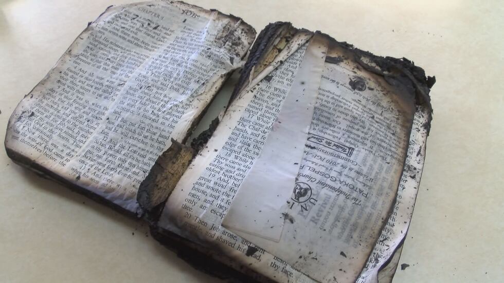 Jerry Lutz was able to find his father's Bible in the charred church debris. (Source: WAVE 3...