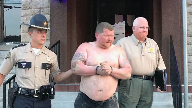 The accused, Dallas Music, escorted to jail by Deputy Taylor McDaniel and Detective Chris...