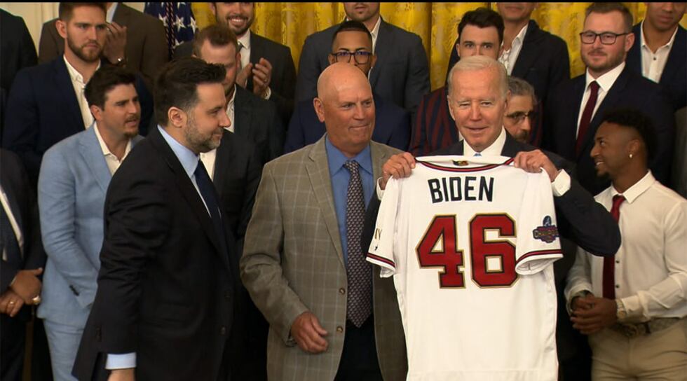 Members of the Atlanta Braves organization present President Joe Biden with a special jersey...
