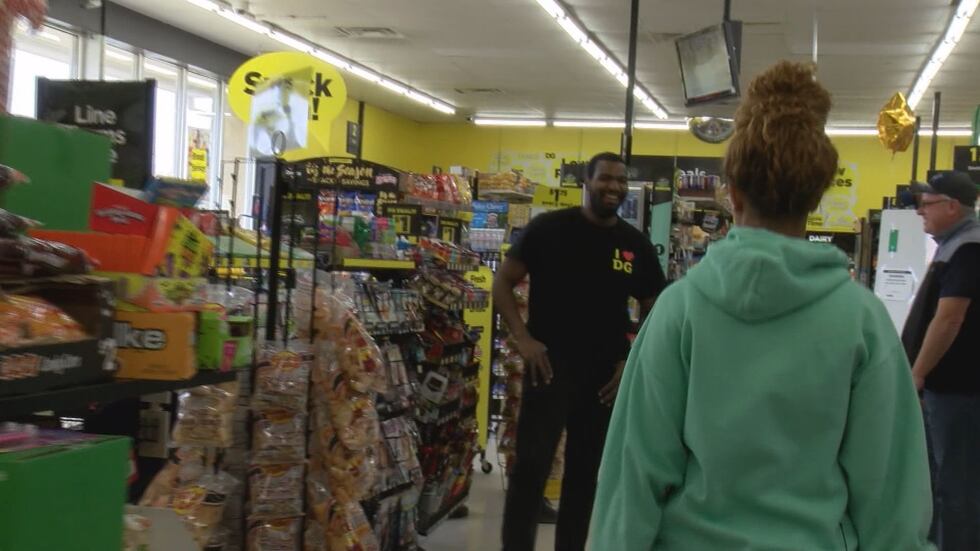 Phoenix O'Neil (right) is greeted by Dollar General manager James Griffith (left).