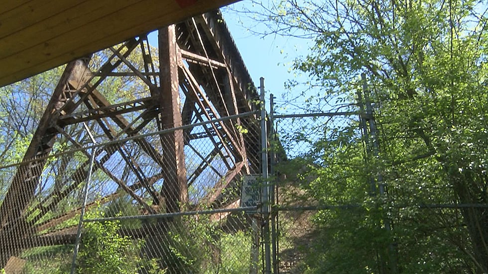 There are fences and warning signs at the bottom of the trestle warning people the tracks are...