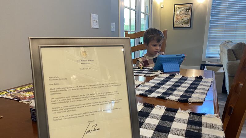 Remy Clark, 7, sits at his dining room table. Beside him is the letter he received from the...