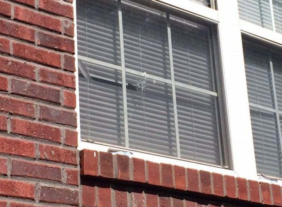 A bullet hole is visible in a window of the boy's house on W. Madison Street. (Source: Maira...