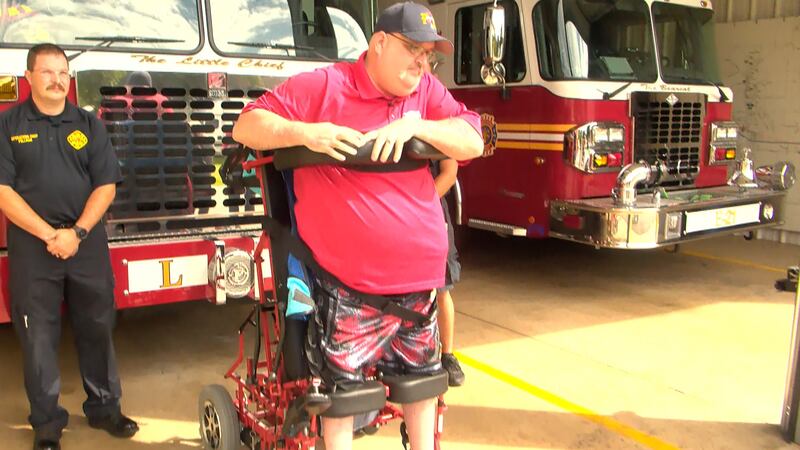 Georgetown Township Assistant Fire Chief Jim Mayfield used his new wheelchair to stand again.