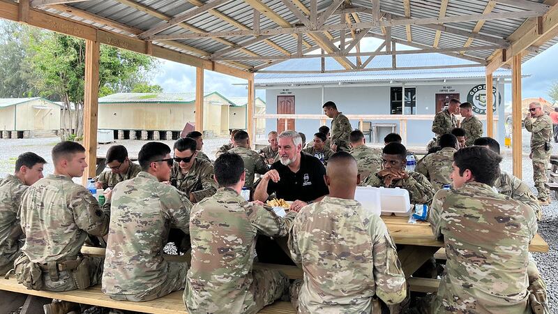 Indiana Gov. Eric Holcomb sits down to eat with members of the Indiana National Guard Nov. 15,...