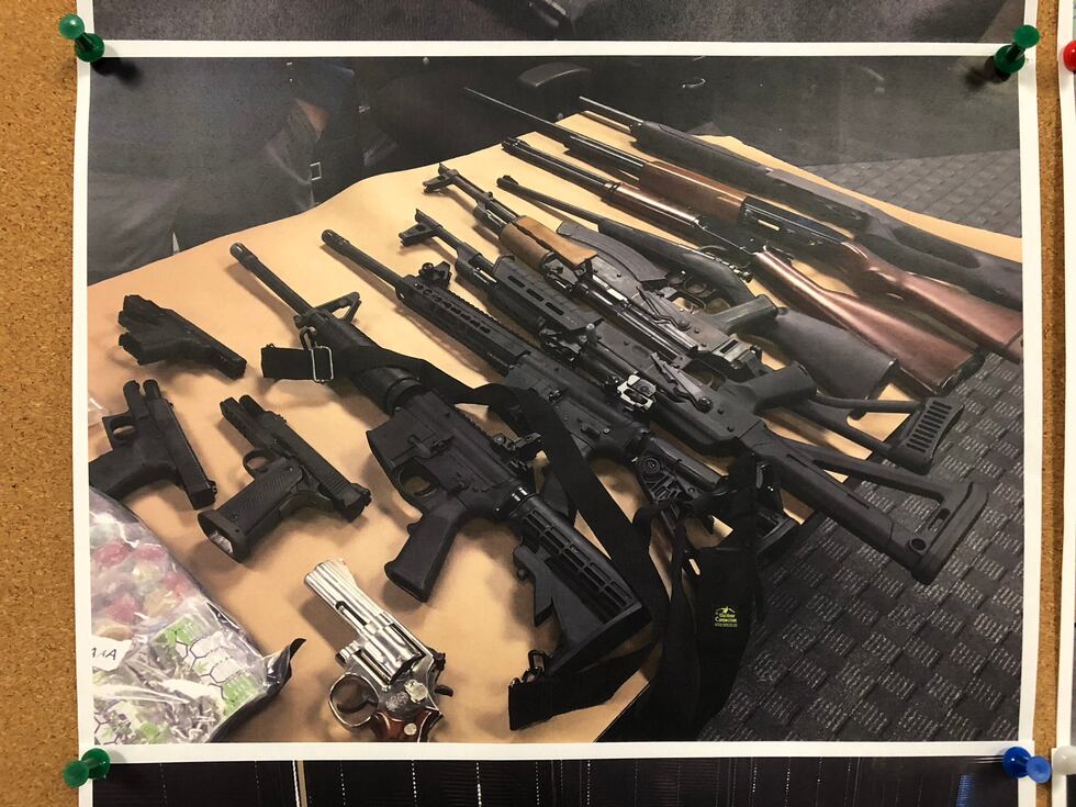 In addition to millions in cash and drugs, police also seized more than a dozen guns.