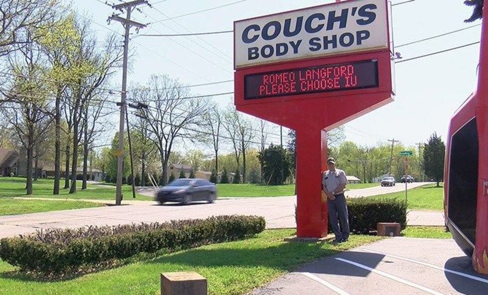 Brian Couch, owner of Couch’s Body and Frame Shop, put up a sign asking Langford to commit to...